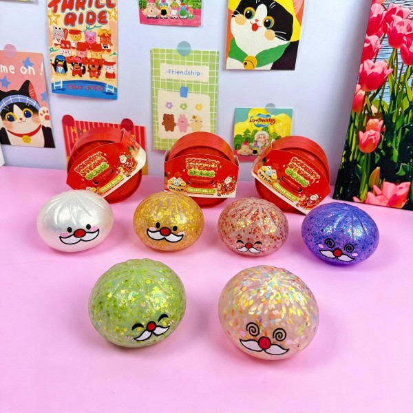 Assorted character squishy ball display packed with glitter filled squeeze balls in printed capsules, ready to set on a counter. Each ball has a molded face and a soft gel core that squishes flat and rebounds slowly. The mix of characters keeps kids digging through the bin, which is what drives the reorder. A complete impulse program in a single carton.