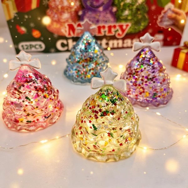 Twelve-piece Christmas tree squishy display in a printed holiday counter box. Each glitter-filled tree is individually boxed, with suspended sparkle that shifts as the soft body squishes and springs back. Assorted colors give the display real shelf presence in a small counter footprint. A reliable stocking-stuffer and teacher-gift program that moves by the dozen.