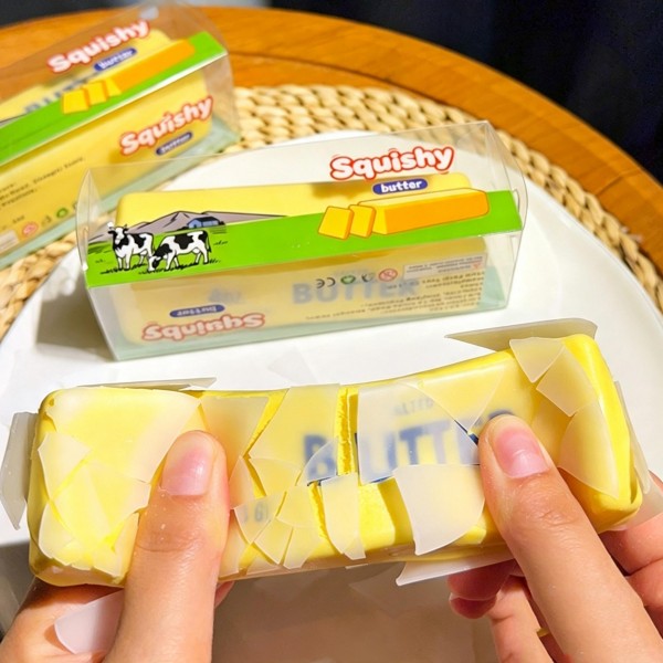 Butter stick squishy printed and molded to look like a wrapped quarter pound block straight out of the fridge. The dense foam gives under a squeeze and rises slowly back into a clean rectangle. A kitchen humor gift that lands every time and a surprisingly good desk fidget. Food novelty like this sells on the joke and reorders on the feel.