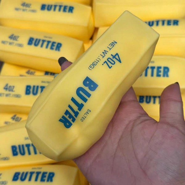 Butter stick squishy shaped and printed like a full block straight from the dairy case. Slow rise foam compresses under a squeeze and slowly returns to shape for repeat fidgeting. A counter impulse toy for boutiques stocking birthday favors, gag gifts, teacher gifts, and stocking stuffers. Realistic food squishies are the piece customers pick up on the way to the register and buy without thinking.