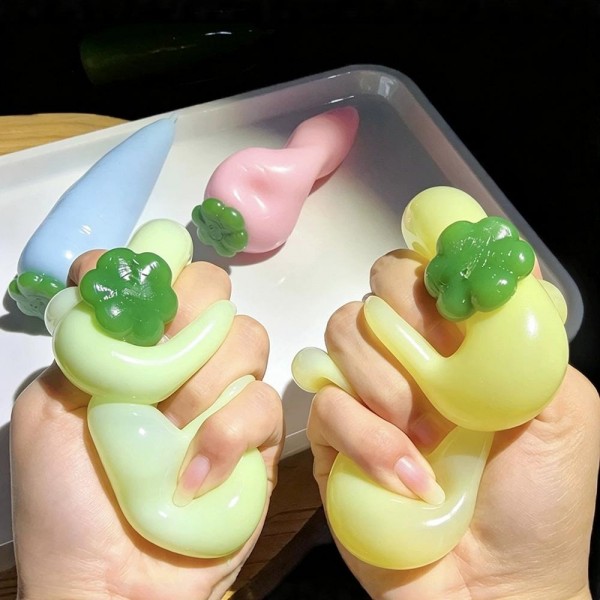 Carrot squishy molded with ridged root detail and a leafy top, stretched long so it fills the hand. The soft body squeezes down the length and rebounds slowly for a satisfying reset. A garden themed desk toy that works for spring displays, Easter baskets, and everyday gifting. Long form squishies like this stand out in a bin and invite a second look.