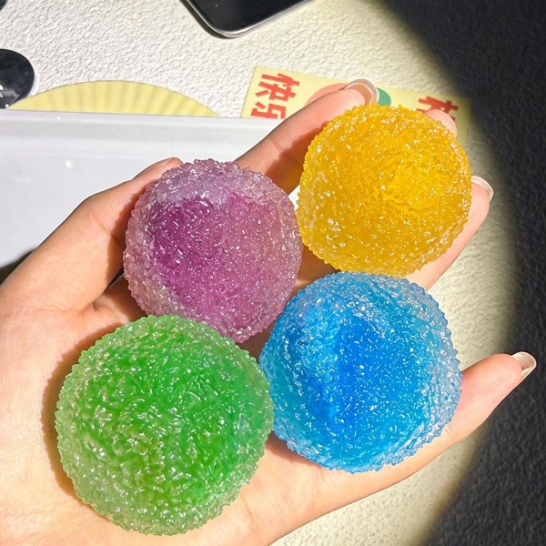 Crackle texture squeeze ball with a bumpy jeweled surface that catches the light and gives your fingers something to grip. The dense gel core takes a hard squeeze and rebounds slowly into a round shape. A tactile stress reliever for desks, classrooms, and travel bags. Bright candy colors merchandise beautifully in a bowl and keep the reorders coming.
