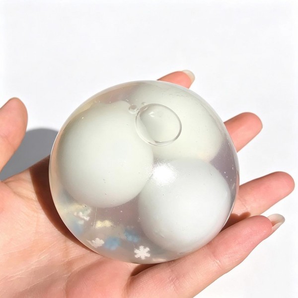 Clear squeeze ball with a stretchy transparent skin and soft shapes suspended inside that shift and separate as you press. Big enough to fill a palm and satisfying to knead with both hands. A calming sensory toy for desks, therapy kits, and quiet time at home. The see through build is a natural demo piece, which is why it moves so well on an open display.