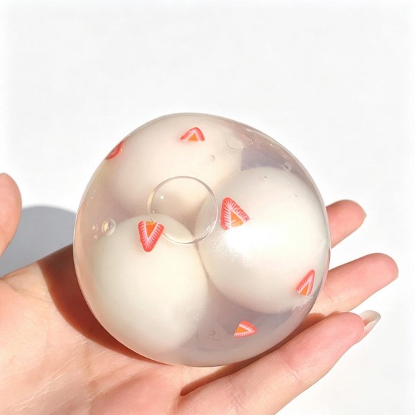 Clear squeeze ball with a stretchy transparent skin and soft shapes suspended inside that shift and separate as you press. Big enough to fill a palm and satisfying to knead with both hands. A calming sensory toy for desks, therapy kits, and quiet time at home. The see through build is a natural demo piece, which is why it moves so well on an open display.