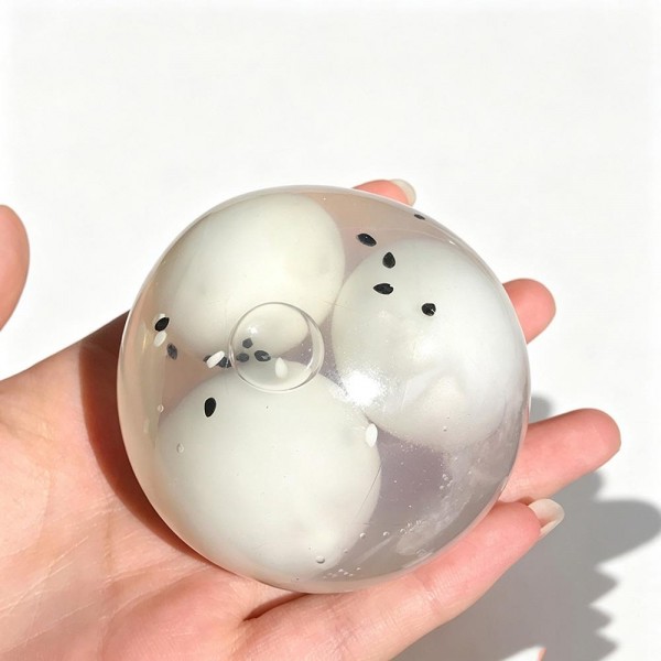 Clear squeeze ball with a stretchy transparent skin and soft shapes suspended inside that shift and separate as you press. Big enough to fill a palm and satisfying to knead with both hands. A calming sensory toy for desks, therapy kits, and quiet time at home. The see through build is a natural demo piece, which is why it moves so well on an open display.