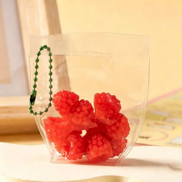 Fruit squishy key ring packed in a clear pouch with a beaded chain, ready to clip onto a backpack, a purse strap, or a set of keys. Each piece is molded and painted to look like fresh cut fruit, with a soft slow rise squeeze that rebounds after every press. A tiny stress reliever that doubles as a bag charm, which is exactly why they disappear off a counter display. Ideal for teen gifting, party favors, and impulse racks.