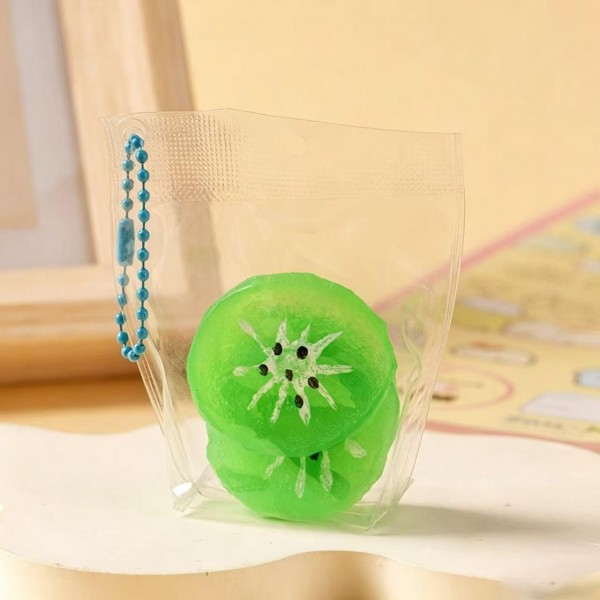 Fruit squishy key ring packed in a clear pouch with a beaded chain, ready to clip onto a backpack, a purse strap, or a set of keys. Each piece is molded and painted to look like fresh cut fruit, with a soft slow rise squeeze that rebounds after every press. A tiny stress reliever that doubles as a bag charm, which is exactly why they disappear off a counter display. Ideal for teen gifting, party favors, and impulse racks.