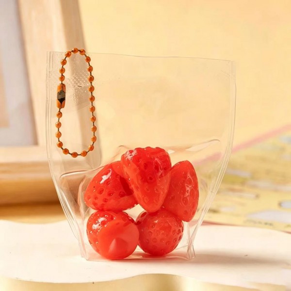 Fruit squishy key ring packed in a clear pouch with a beaded chain, ready to clip onto a backpack, a purse strap, or a set of keys. Each piece is molded and painted to look like fresh cut fruit, with a soft slow rise squeeze that rebounds after every press. A tiny stress reliever that doubles as a bag charm, which is exactly why they disappear off a counter display. Ideal for teen gifting, party favors, and impulse racks.
