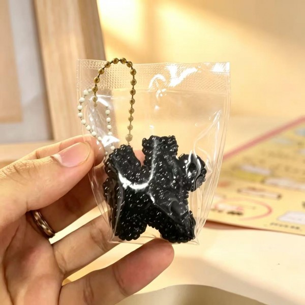 Fruit squishy key ring packed in a clear pouch with a beaded chain, ready to clip onto a backpack, a purse strap, or a set of keys. Each piece is molded and painted to look like fresh cut fruit, with a soft slow rise squeeze that rebounds after every press. A tiny stress reliever that doubles as a bag charm, which is exactly why they disappear off a counter display. Ideal for teen gifting, party favors, and impulse racks.