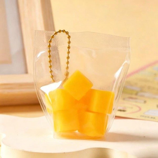 Fruit squishy key ring packed in a clear pouch with a beaded chain, ready to clip onto a backpack, a purse strap, or a set of keys. Each piece is molded and painted to look like fresh cut fruit, with a soft slow rise squeeze that rebounds after every press. A tiny stress reliever that doubles as a bag charm, which is exactly why they disappear off a counter display. Ideal for teen gifting, party favors, and impulse racks.