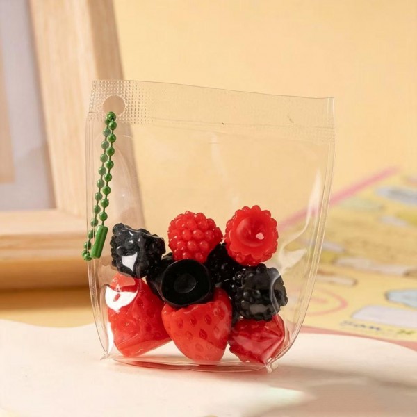 Fruit squishy key ring packed in a clear pouch with a beaded chain, ready to clip onto a backpack, a purse strap, or a set of keys. Each piece is molded and painted to look like fresh cut fruit, with a soft slow rise squeeze that rebounds after every press. A tiny stress reliever that doubles as a bag charm, which is exactly why they disappear off a counter display. Ideal for teen gifting, party favors, and impulse racks.