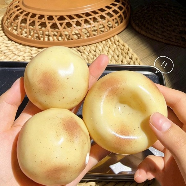 Potato squishy in a soft translucent gel, freckled and dimpled so it reads like a real spud. The stretchy skin flattens into a puddle under a press and slowly pulls itself back into a dome. A counter impulse toy for boutiques stocking gag gifts, classroom rewards, sensory bins, and stocking stuffers. Novelty food squishies are the piece customers cannot put down once they touch it.