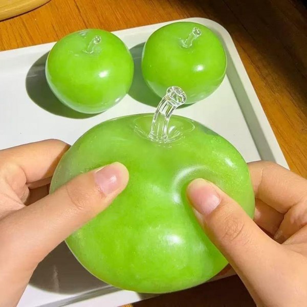 Apple squishy molded to fruit stand scale with a dimpled stem well, a smooth skin finish, and a satisfying slow rise squeeze. Sturdy enough for daily desk duty and cute enough to sit out as decor. A natural fit for teacher gifts, classroom rewards, and back to school displays. Realistic fruit squishies photograph beautifully and turn fast in a basket at the counter.