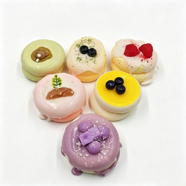 Mini cake squishy sculpted like a bakery case dessert, with piped frosting, a glossy drip, and tiny fruit and cream details on top. The slow rise foam holds its shape after every squeeze, so it stays photo ready on a shelf or a register display. A charming pick for dessert lovers, teachers, and anyone building a cute desk collection. Realistic food squishies like these are proven impulse sellers.