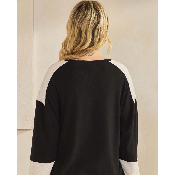 Color block waffle knit henley top with a buttoned placket and a relaxed drop-shoulder silhouette. Soft ribbed-texture knit gives the oversized cut structure, while contrast panels at the shoulders and cuffs add visual interest to an everyday staple. Easy to layer over leggings, denim, or bike shorts for weekend errands, school pickup, and cozy fall weather. A transitional long sleeve top that turns fast for boutiques building comfortable seasonal assortments.