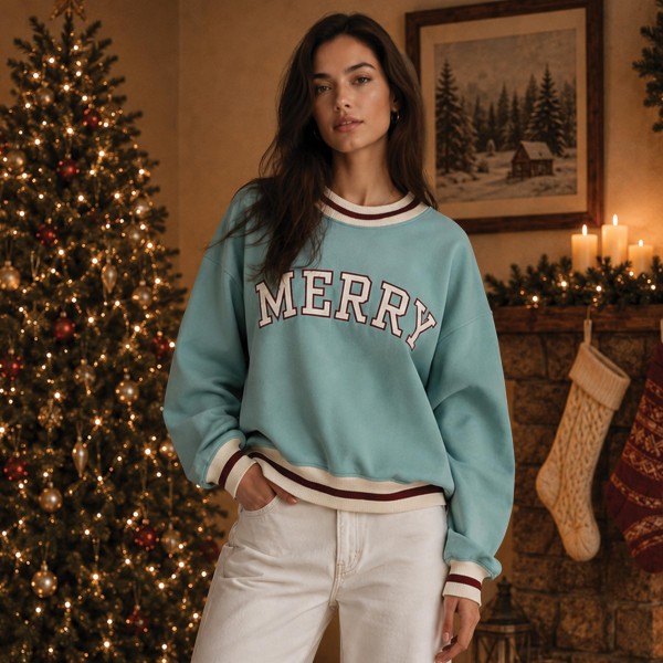 MERRY Varsity Letter Sweatshirt with bold appliqué lettering across the chest and striped ribbed trim at the neckline, cuffs, and hem. A soft, relaxed pullover that pairs easily with jeans, leggings, or flannel pajama pants. Great for holiday parties, Christmas morning photos, cookie swaps, and cozy weekends all season long. Collegiate style holiday tops are a customer favorite, making this an easy add to any Christmas display.