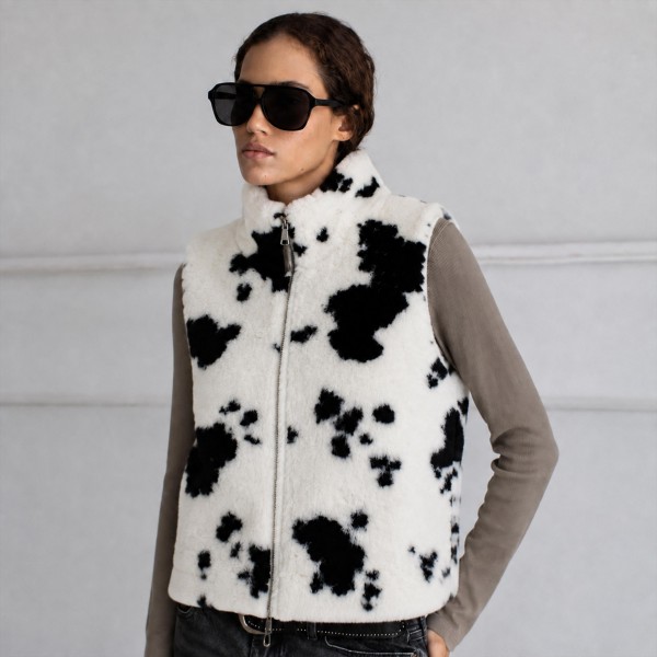 Faux Fur Cow Print Vest with a plush, shaggy pile and a bold western inspired cow pattern. Layer it over sweaters, flannels and button downs for instant warmth and texture on chilly days. A statement layering piece for fall festivals, game days, holiday gatherings and rodeo season. Cow print is a standout trend, and this cozy vest gives shoppers an easy way to wear it.