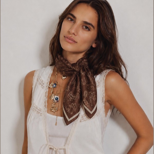 Paisley print bandana scarf cut from a lightweight woven fabric with a soft drape. The square knots easily at the throat, wraps a ponytail, or ties onto a tote handle for a quick refresh. Rolled edges keep it looking finished after repeated wear. A versatile print scarf that reads elevated at an impulse price, which makes it an easy multiple sale.