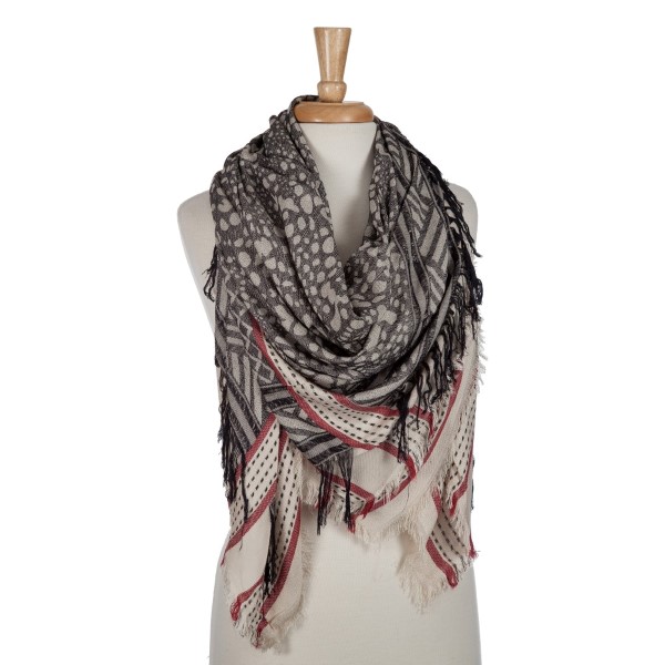 Beige and black lightweight printed blanket scarf with fringe details. 100% viscose. 