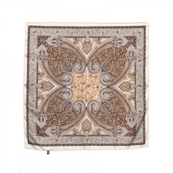 Paisley Print Bandana Scarf, a 27.5 inch square of silky 100% polyester printed with an ornate paisley medallion and a detailed border. Tie it at the neck, wear it as a headscarf or bandana, or knot it onto a handbag strap for an instant update. The classic paisley pattern pairs easily with denim, western looks, and cozy fall layers. A versatile accessory at an easy impulse price, this square scarf is a simple addition that sells right off the counter.