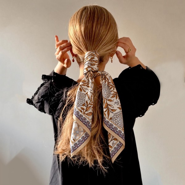 Botanical Print Square Scarf in silky 100% polyester, measuring 27.5 inches square. A detailed print of blooms, vines, and leaves is framed by a patterned border for a classic, collected look. Wear it at the neck with a crisp button down, tie it around a ponytail, or knot it onto a handbag. Offered in several colorways, it is a versatile everyday accessory that customers can style a dozen ways.