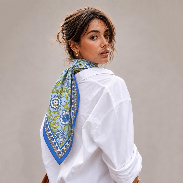 Botanical Print Square Scarf in silky 100% polyester, measuring 27.5 inches square. A detailed print of blooms, vines, and leaves is framed by a patterned border for a classic, collected look. Wear it at the neck with a crisp button down, tie it around a ponytail, or knot it onto a handbag. Offered in several colorways, it is a versatile everyday accessory that customers can style a dozen ways.