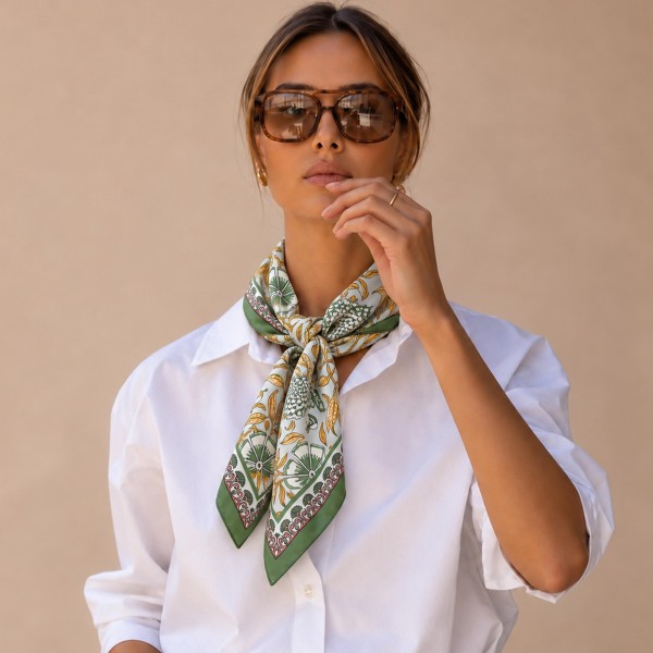 Botanical Print Square Scarf in silky 100% polyester, measuring 27.5 inches square. A detailed print of blooms, vines, and leaves is framed by a patterned border for a classic, collected look. Wear it at the neck with a crisp button down, tie it around a ponytail, or knot it onto a handbag. Offered in several colorways, it is a versatile everyday accessory that customers can style a dozen ways.