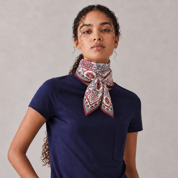 Botanical Print Square Scarf in silky 100% polyester, measuring 27.5 inches square. A detailed print of blooms, vines, and leaves is framed by a patterned border for a classic, collected look. Wear it at the neck with a crisp button down, tie it around a ponytail, or knot it onto a handbag. Offered in several colorways, it is a versatile everyday accessory that customers can style a dozen ways.