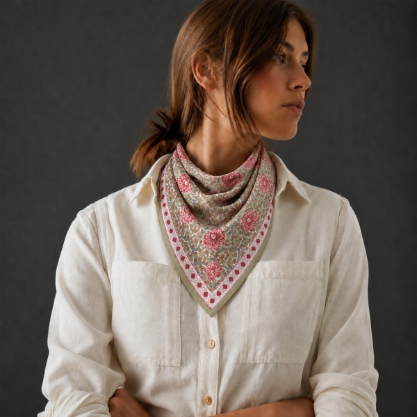 Floral Print Square Scarf in silky 100% polyester, measuring 27.5 inches square. Block print inspired blooms and trailing leaves fill the center, finished with a dotted floral border. Tie it at the neck, wear it as a hair scarf, or knot it around a bag strap for an instant update. A pretty, easy to style piece that works with sweaters, blazers, and tees, and makes a simple gift at an easy price.