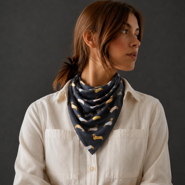 Dachshund Print Square Scarf with a silky, lightweight feel and rows of playful wiener dogs in cozy sweaters. Tie it at the neck, wear it in the hair, or knot it around a bag strap for a fun pop of personality. A sweet gift for dog moms, dachshund lovers, and anyone who adores their pup. Novelty prints like this one turn fast as impulse buys and easy gifts.