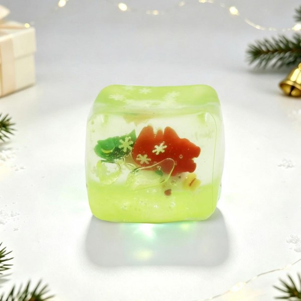 Christmas Jelly Cube Squishy

Christmas Jelly Cube Squishy shaped like a glossy ice cube with festive charms floating inside, including gingerbread men, snowmen, mittens, and snowflake confetti. The clear, rubbery shell is filled with a thick, gooey jelly that gives a slow, dense squeeze, then gradually settles back into a perfect cube. It feels smooth and cool in the hand and looks like a mini holiday snow globe sitting on a desk. Ice cube squishies are one of the hottest textures right now, and this Christmas version is a natural stocking stuffer.

- Holiday charms sealed inside the clear cube