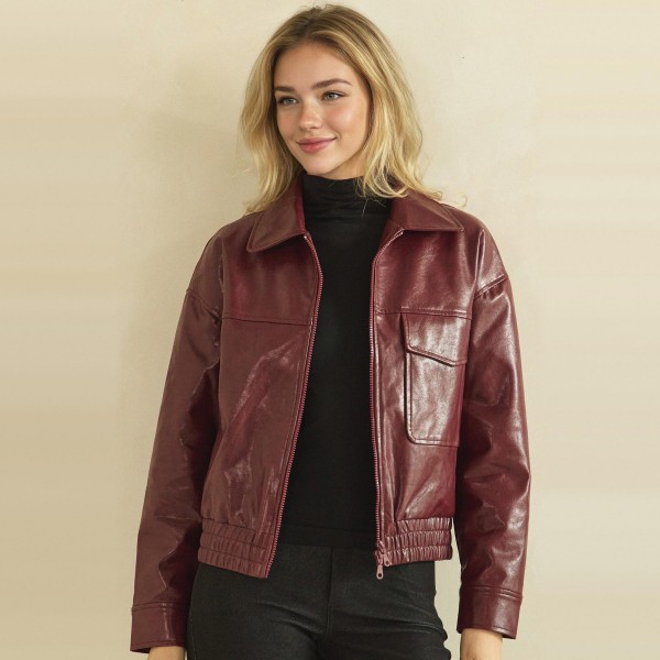 Faux Leather Bomber Jacket with a classic point collar, full zip front, flap chest pockets, and a smocked elastic waistband for a flattering cinched fit. The soft vegan leather has a rich, buttery finish that layers easily over turtlenecks, tees, and sweaters. A versatile outerwear piece for crisp fall days, game nights, and weekend errands. Boutique shoppers love an affordable leather look, and this bomber silhouette sells season after season.