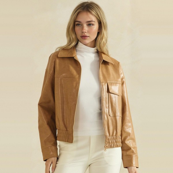 Faux Leather Bomber Jacket with a classic point collar, full zip front, flap chest pockets, and a smocked elastic waistband for a flattering cinched fit. The soft vegan leather has a rich, buttery finish that layers easily over turtlenecks, tees, and sweaters. A versatile outerwear piece for crisp fall days, game nights, and weekend errands. Boutique shoppers love an affordable leather look, and this bomber silhouette sells season after season.