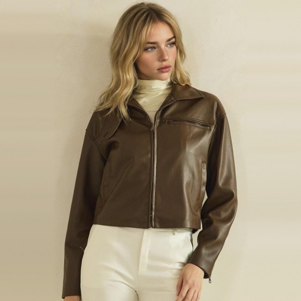 Cropped Faux Leather Jacket with a full zip front, wide point collar, and zippered chest pocket. The soft vegan leather has a smooth, supple finish and a boxy cropped fit that pairs perfectly with high waisted jeans, dresses, and wide leg pants. An easy layering piece for cool fall evenings, concerts, and weekend outings. Faux leather jackets are a top seasonal request, and this cropped cut gives customers a modern take that moves fast.