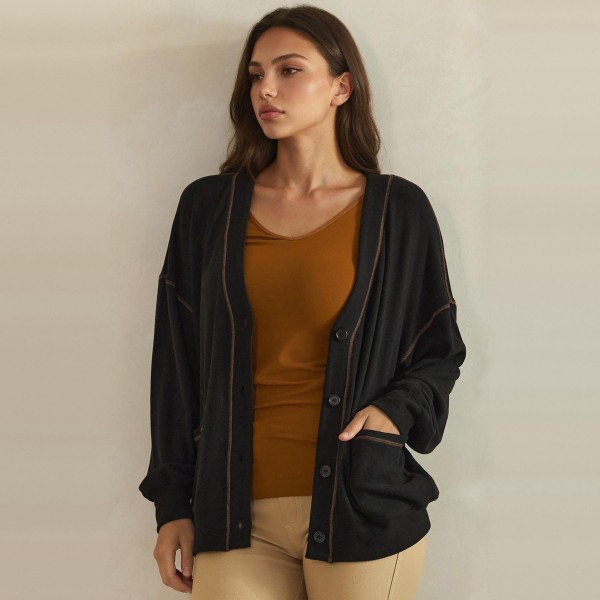 Button Front Knit Cardigan with a relaxed V neckline, dropped shoulders, and two roomy front pockets. The soft midweight knit layers easily over tanks, tees, and camis without adding bulk. Perfect for chilly mornings, office layering, and cozy weekend outfits from early fall straight through winter. A classic cardigan your customers will reach for again and again, making it a dependable repeat seller for boutique racks.