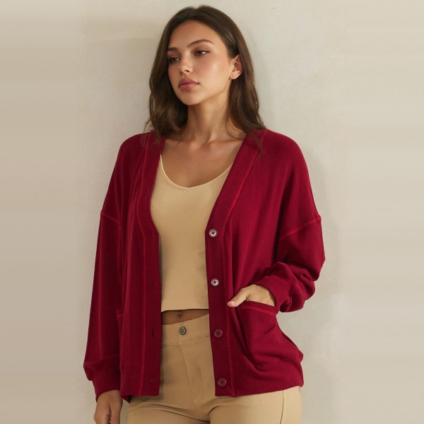 Button Front Knit Cardigan with a relaxed V neckline, dropped shoulders, and two roomy front pockets. The soft midweight knit layers easily over tanks, tees, and camis without adding bulk. Perfect for chilly mornings, office layering, and cozy weekend outfits from early fall straight through winter. A classic cardigan your customers will reach for again and again, making it a dependable repeat seller for boutique racks.
