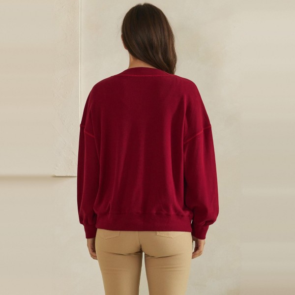 Button Front Knit Cardigan with a relaxed V neckline, dropped shoulders, and two roomy front pockets. The soft midweight knit layers easily over tanks, tees, and camis without adding bulk. Perfect for chilly mornings, office layering, and cozy weekend outfits from early fall straight through winter. A classic cardigan your customers will reach for again and again, making it a dependable repeat seller for boutique racks.
