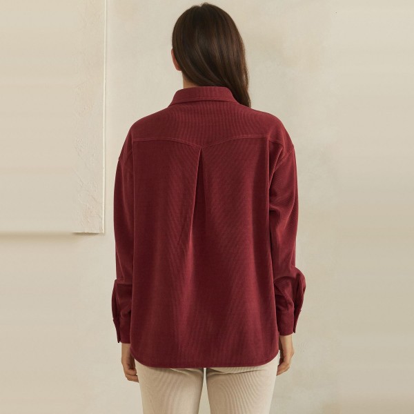 Corduroy Pullover Shirt with a classic point collar, half button placket, and flap chest pocket. The soft wale corduroy has a relaxed oversized fit with dropped shoulders and buttoned cuffs for an effortless, lived in look. Customers can wear it on its own with jeans or leggings, or layer it over a turtleneck for crisp fall days. A cozy statement top with a vintage inspired feel, this style is a natural fit for autumn displays and sells quickly.