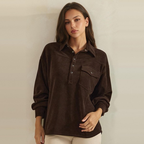 Corduroy Pullover Shirt with a classic point collar, half button placket, and flap chest pocket. The soft wale corduroy has a relaxed oversized fit with dropped shoulders and buttoned cuffs for an effortless, lived in look. Customers can wear it on its own with jeans or leggings, or layer it over a turtleneck for crisp fall days. A cozy statement top with a vintage inspired feel, this style is a natural fit for autumn displays and sells quickly.