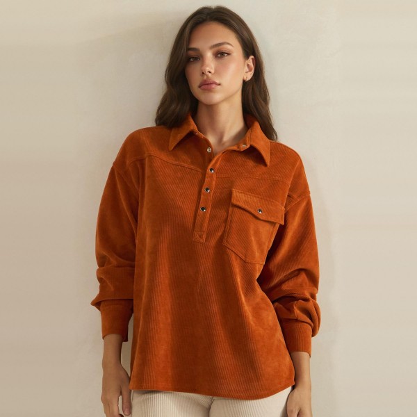 Corduroy Pullover Shirt with a classic point collar, half button placket, and flap chest pocket. The soft wale corduroy has a relaxed oversized fit with dropped shoulders and buttoned cuffs for an effortless, lived in look. Customers can wear it on its own with jeans or leggings, or layer it over a turtleneck for crisp fall days. A cozy statement top with a vintage inspired feel, this style is a natural fit for autumn displays and sells quickly.
