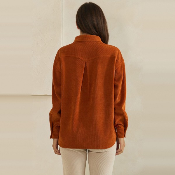 Corduroy Pullover Shirt with a classic point collar, half button placket, and flap chest pocket. The soft wale corduroy has a relaxed oversized fit with dropped shoulders and buttoned cuffs for an effortless, lived in look. Customers can wear it on its own with jeans or leggings, or layer it over a turtleneck for crisp fall days. A cozy statement top with a vintage inspired feel, this style is a natural fit for autumn displays and sells quickly.