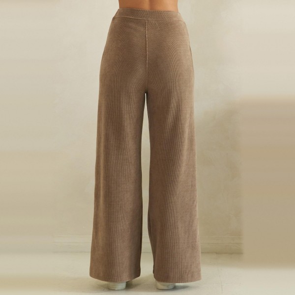Ribbed Wide Leg Pants with a soft corded knit texture, comfortable elastic waistband, and roomy front patch pockets. The relaxed high rise fit falls into a full length wide leg that drapes beautifully and flatters every shape. Customers can dress them up with a fitted knit and boots or keep it cozy with a sweatshirt and sneakers for fall weekends, travel days, and casual Fridays. Easy to fit and endlessly versatile, these comfy fall pants are a reliable repeat seller for any boutique.