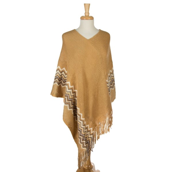 Knit poncho with a chevron pattern along the bottom and metallic detailing. 100% acrylic. One size fits most. 