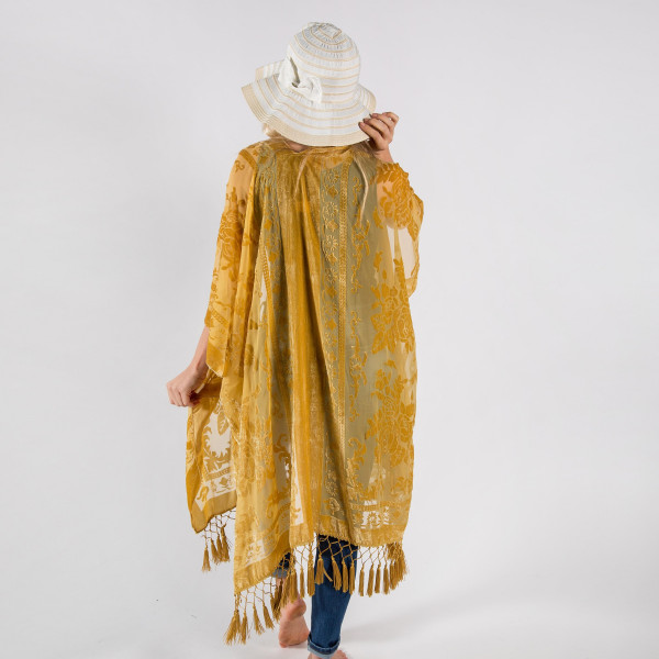 Gold floral kimono with tassels. One size fits most 0-14. Measures approximately 42" x 36" in size. 50% Viscose, 50% Nylon.