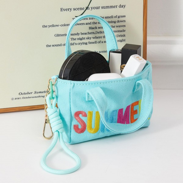 A fun and fashion-forward structured mini handbag featuring bold 'SUMMER' lettering in vibrant multicolor embroidery, with a removable wrist strap for hands-free convenience. The compact boxy design works perfectly as a daytime grab-and-go bag, beach accessory, or festival essential. Ideal for boutiques refreshing their warm-weather accessories assortment, this eye-catching piece drives impulse purchases and pairs effortlessly with seasonal apparel. A cheerful, trend-right addition customers will reach for all summer long.