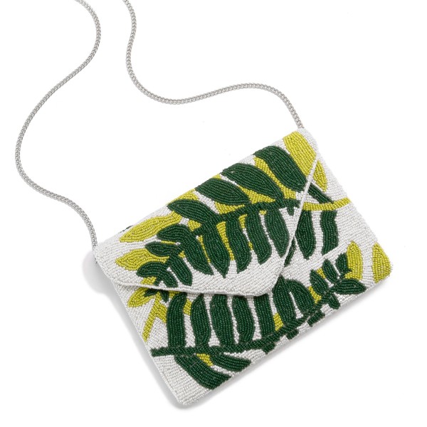 Seed Bead Fern Fronds Cross Body Envelope Bag

- Magnetic Closure
- Lined Inside
- Chain Strap
- One Open Inner Pocket
- Approximately 10" L x 7" T
- Strap Drop Approximately 20" L
- 100% Cotton