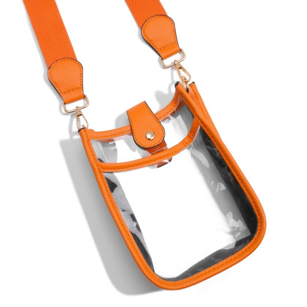 Clear PU Cross Body Bag With Leather Walls and Trim Featuring Leather Snap Latch Closure
- One Outer Open Pocket
- Detachable/Adjustable Canvas Strap
- Approximately 8" T x 6" L x 3" W
- Strap Drop 15" - 24" L