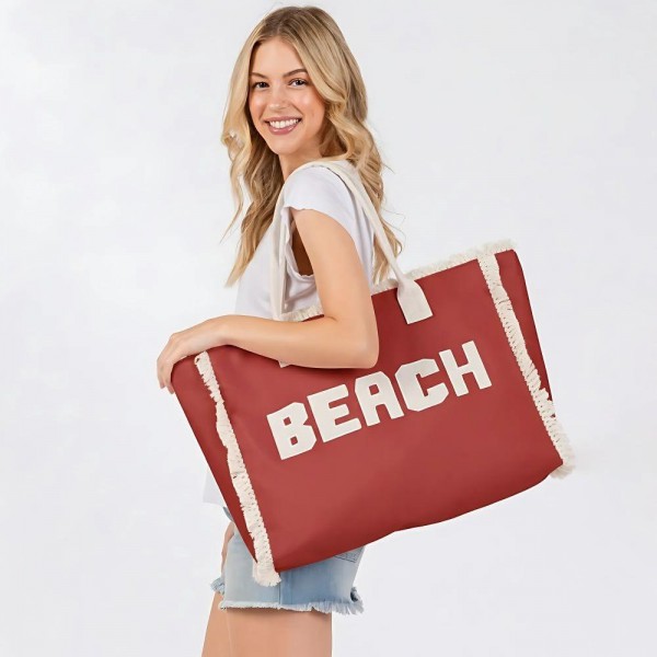 Canvas Tote Bag With "BEACH" Embroidered Canvas Patches Featuring Fringes Accents 

- Full Zipper Closure
- Lined Body with Open Pocket
- Approximately 22.5" L X 13.5" T X 5" D
- Strap Drop 8" L
- 100% Polyester