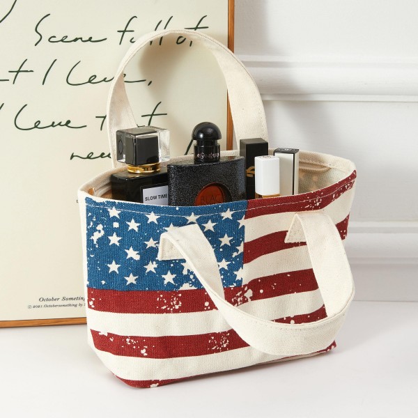 A striking canvas mini tote with bold all-over American flag coverage — stars-and-stripes from top to bottom for maximum patriotic impact. Lightweight with sturdy top handles, this carryall is designed for summer celebrations, beachside outings, and seasonal gifting. Appeals to shoppers with a strong patriotic sensibility and sells especially well during Fourth of July and Memorial Day selling periods. An easy add-on that strengthens any Americana-themed summer display.