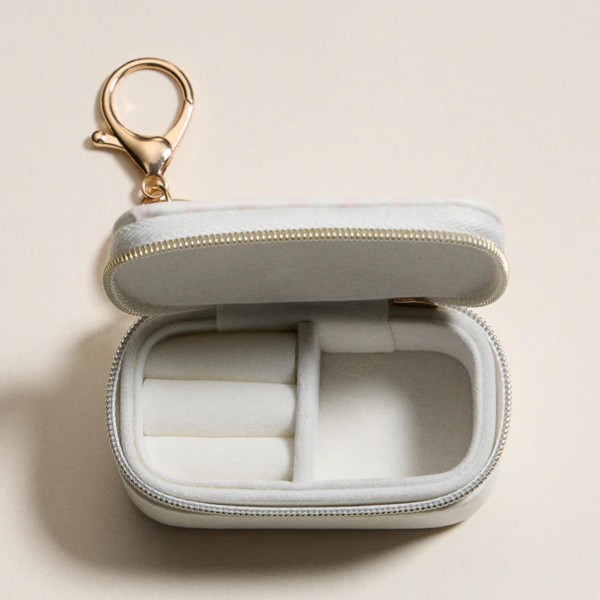 Vegan Leather Stripes & Bows Print Jewelry Box Key Ring 

- Full Zip Closure 
- Earring Holder 
- 2 Ring Slots 
- Approximately 1.5" T X 3" L